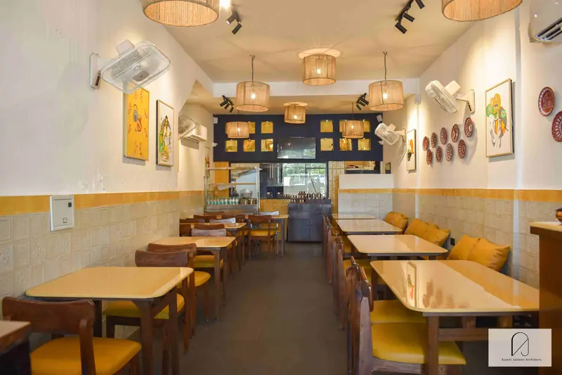 Chennai Maratha, Zirakpur: restaurant dining room with timber tables and woven pendant lights