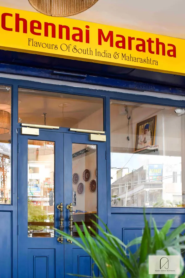 Chennai Maratha, Zirakpur: blue glazed double doors under the yellow restaurant sign